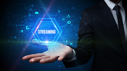 Man hand holding STREAMING inscription, social media concept