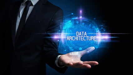 Man hand holding DATA ARCHITECTURE inscription, technology concept