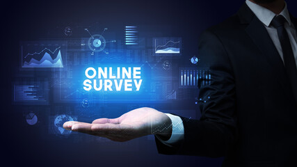 Hand of Businessman holding ONLINE SURVEY inscription, business success concept