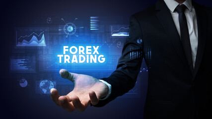 Hand of Businessman holding FOREX TRADING inscription, business success concept