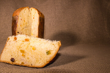 slice of chocolate cake panettone on the wood table. photo close up