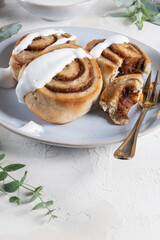 Cinnamon rolls or cinnabon  with icing for Christmas. Homemade traditional winter festive dessert buns. Pastry food for breakfast on white background