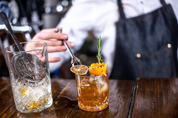Girl barman makes a cocktail in the pothouse