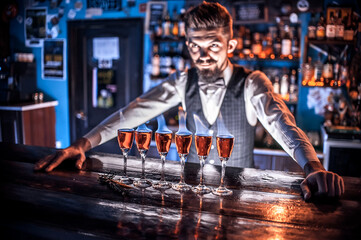 Expert bartender makes a cocktail in the nightclub