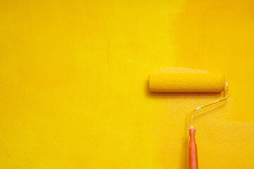Roller Brush Painting, Worker painting on surface wall  Painting apartment, renovating with yellow...
