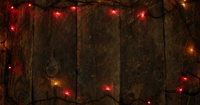 New Year's wooden background with garland lights.