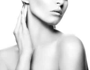 Part of face of beauty model woman touching beautiful neck. Natural make-up, clean fresh skin. Isolated over white background, monochrome. Black and white