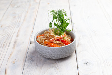 Traditional dish of noodles with vegetables. On a light background.