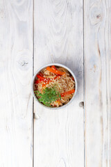Traditional dish of noodles with vegetables. On a light background.