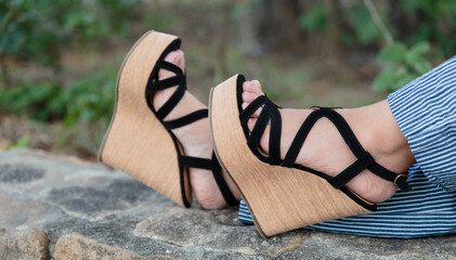 Closeup shot of female feet wearing cork wedge sandals
