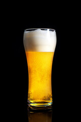  fresh beer in a beautiful tall glass on a black background