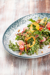 Duck breast salad with potato chips and fresh vegetables. On a decorative plate