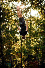 view of man skillfully jumps and performs trick upside down in the air