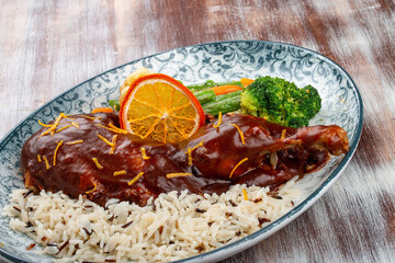 Duck in orange sauce with blanched vegetables and rice