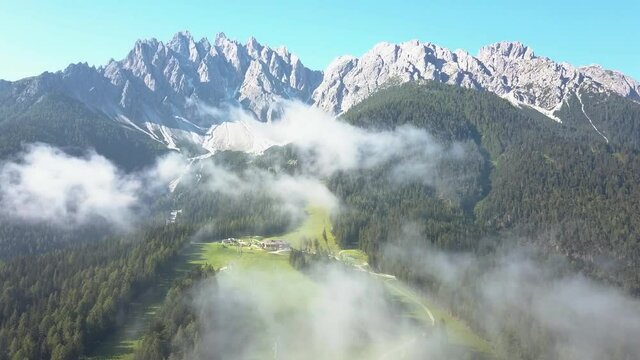 Aerial over the clouds, A Ski slope during summer taken from Sporthotel Tyrol in Innichen, Dolomite Italy
