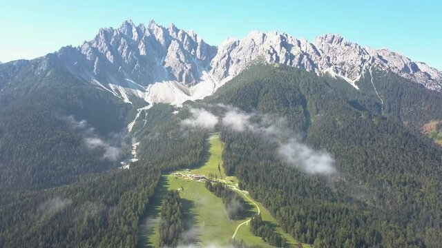 Ski slope during the summer in Innichen South Tirol, green no snow, mountain top peaks