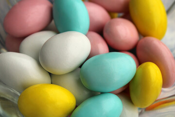 Almond candies close up view, colored sweets background