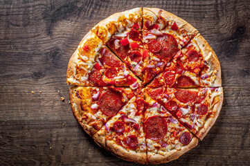 Pepperoni Pizza with Mozzarella cheese, salami, Tomato sauce, pepper, Spices. Italian pizza on wooden table background