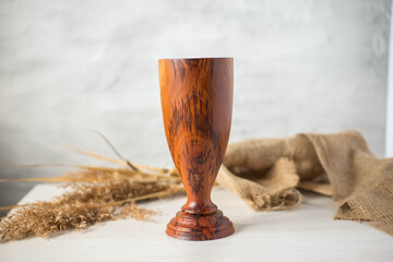 Glass made of wood. Craft wooden glass. Handmade wooden tableware.