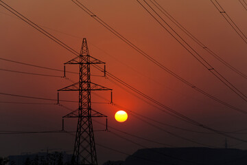 Sunset behind high voltage power towers