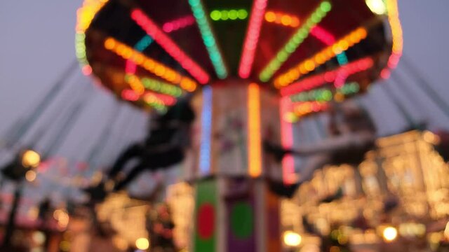 Blurred defocused video of spinning christmas carousel in colorful lights