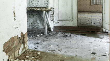 abandoned village room with dirty floor and old cement wall