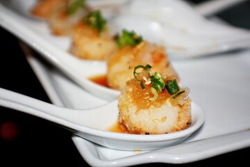 Tasteful display of appetizers in white ceramic spoons