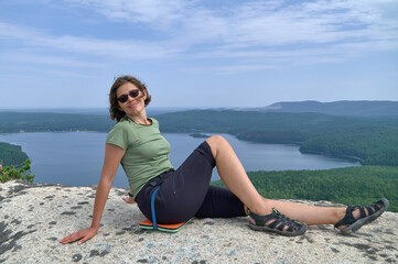 Woman sitting on the top of rock