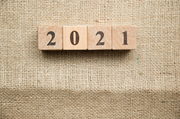Happy New Year 2021 Christmas and New Year background. Symbol from number. Wooden cubes on canvas.