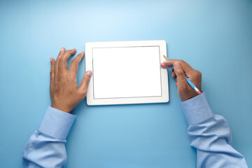 man's hand working on digital tablet on office desk 