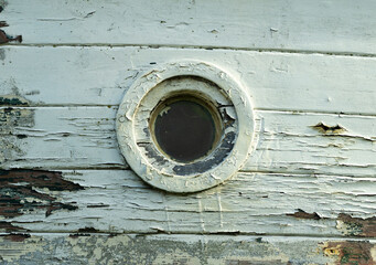 Small porthole in an old boat