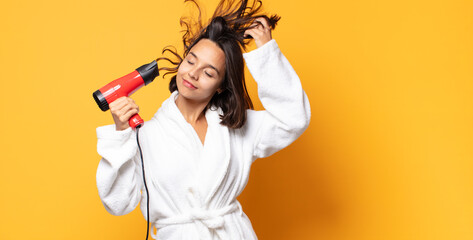 hispanic pretty woman with a hair dryer