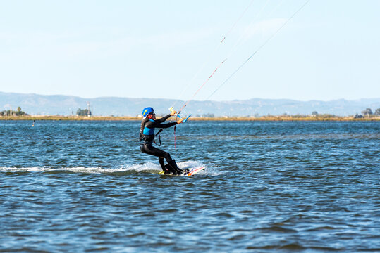 DELTA DEL EBRO, SPAIN - Oct 13, 2020: People practicing kite Surfing in Platja del Trabucador in the D