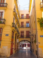 Beautiful typical spanish yellow street in Valencia, Spain. Colorful and historic architecture.