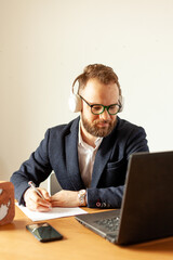 a man in a suit works from home with a laptop computer