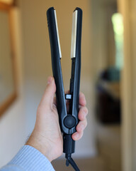 Hair Straighteners in hand
