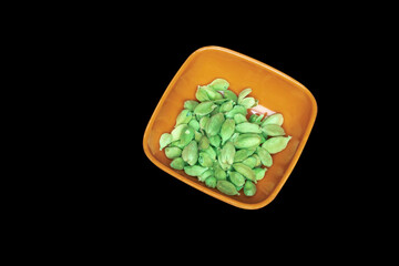 green cardmom in bowl isolated black background