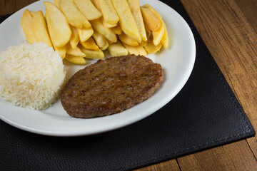 Close-up of food combined with a tasty hamburger with rice and fries. Popular gastronomic photography.