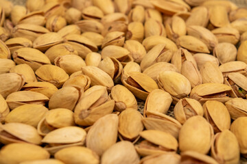 Salted pistachios lie on the burlap. Close up.