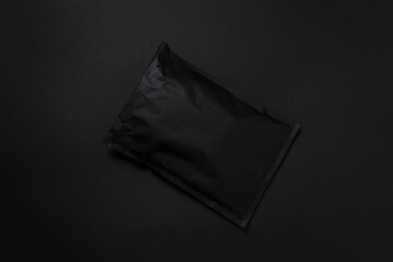 Black paper bubble envelope on dark background