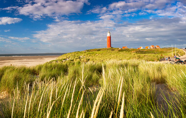 Bright sunlight during sunset over iconic red lighthouse at the island of Texel, The Netherlands