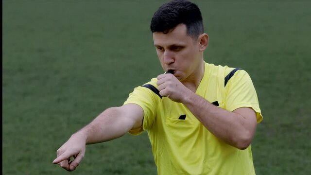 Referee goes watching VAR or violation of the rules and shows a penalty, yellow or red card . Concept of sport, rules violation, offside