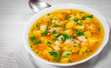 Fish soup with vegetables in bowl