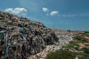 A large pile of plastic waste and blue sky