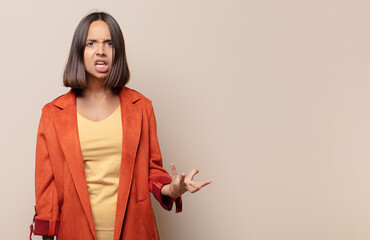 young woman looking angry, annoyed and frustrated screaming wtf or what’s wrong with you