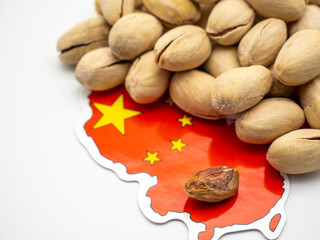pistachio and china flag on white commerce export concept