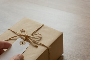 Tagged parcel on the table. Luggage, gift, parcel, delivery service, sending, receiving,...