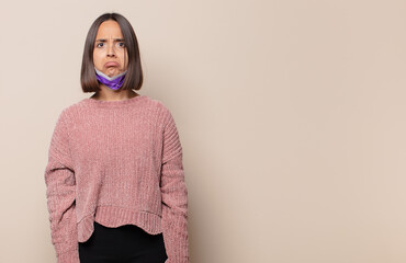 young woman feeling sad and whiney with an unhappy look, crying with a negative and frustrated...