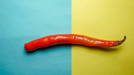Indian Spicy masala chilly on blue and yellow background