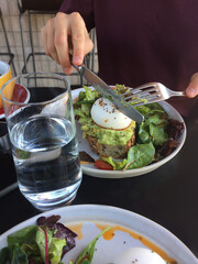 avocado sandwich with egg and red fish in a cafe